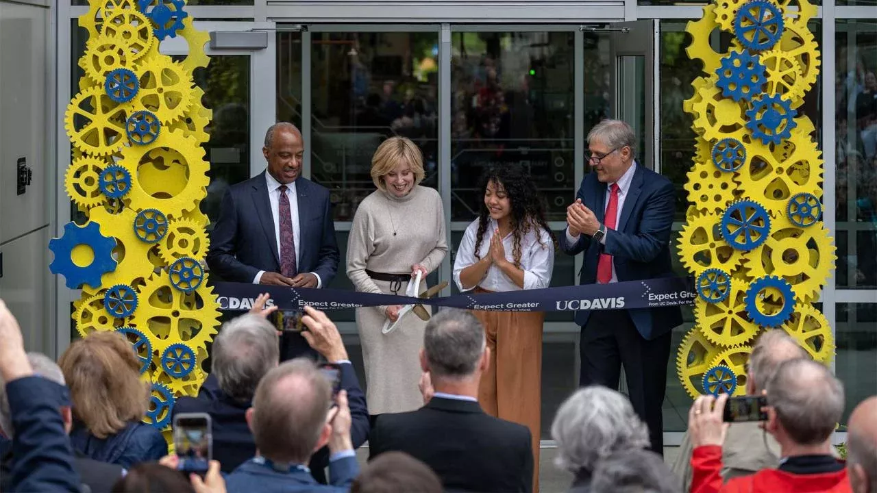 Diane Bryant ’85 cuts the ribbon to open the Engineering Student Design Center that bears her name as Chancellor Gary S. May, mechanical engineering major Tichada Tantasirikorn and Dean Richard Corsi look on. (José Luis Villegas/UC Davis)