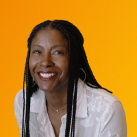Portrait of Victoria Coleman smiling against an orange and yellow gradient background.