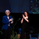 Sue Ebeler accepting the award from Kelly Brown on stage.